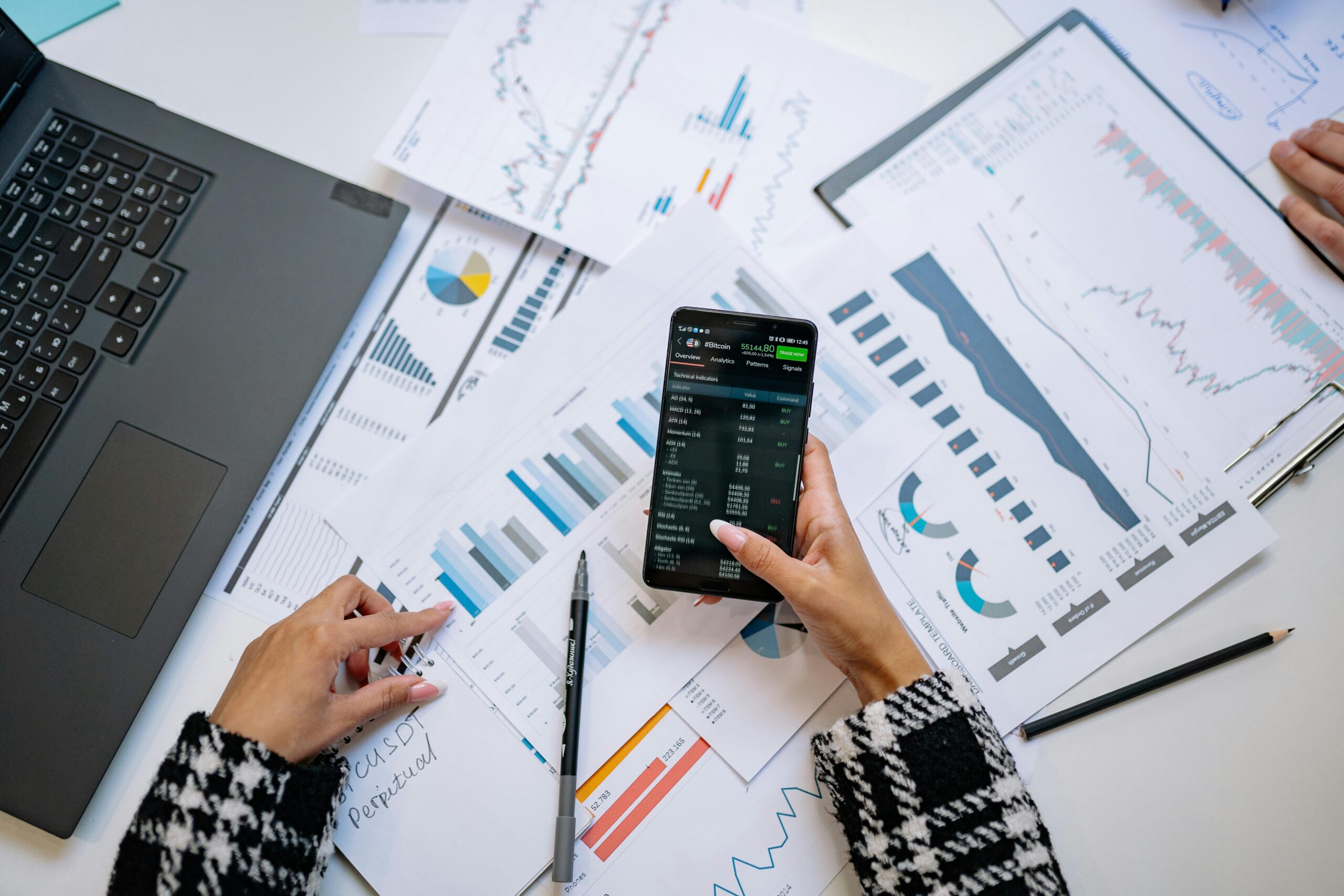 relax-atmosphere A top view on charts and smartphone in an office, showcasing data analytics.